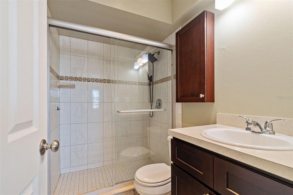 2307 Bay Boulevard Indian Rocks Beach, FL 33785 - Photo 54 of 85 a bathroom with a sink a toilet and shower