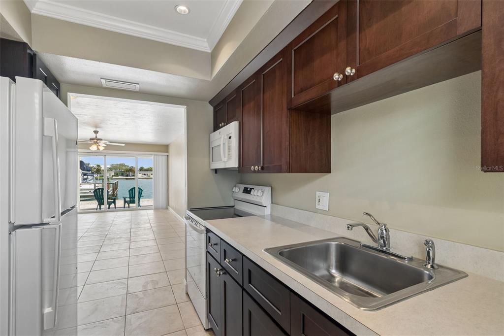 2307 Bay Boulevard Indian Rocks Beach, FL 33785 - Photo 60 of 85 a kitchen with a sink and a refrigerator