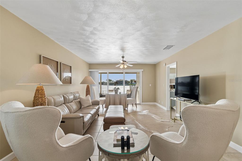 2307 Bay Boulevard Indian Rocks Beach, FL 33785 - Photo 6 of 85 a living room with furniture a fireplace and a flat screen tv