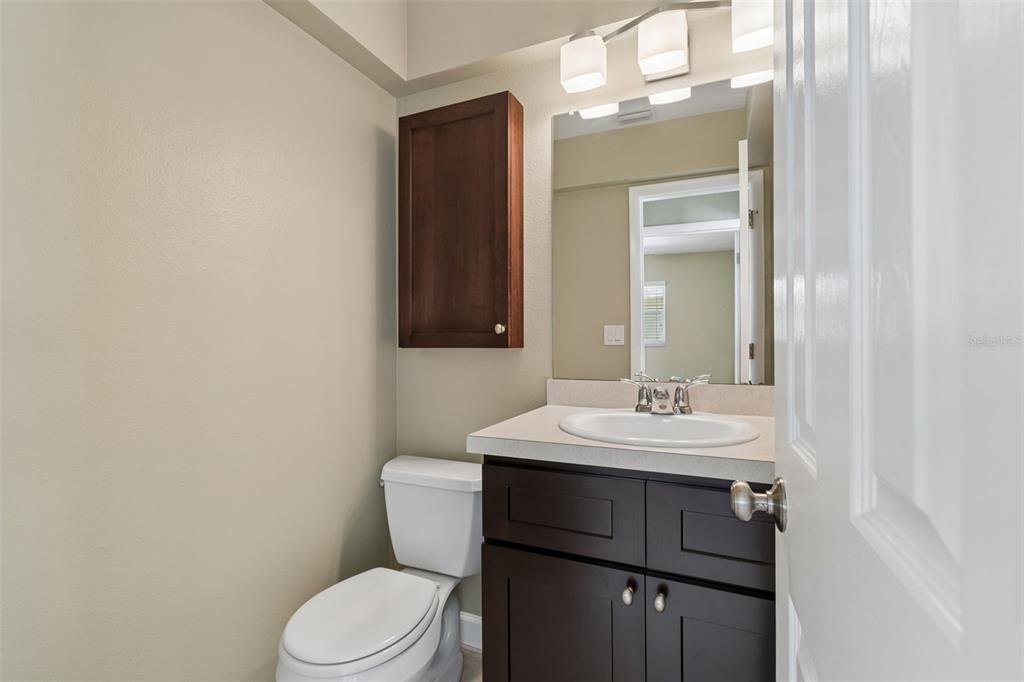 2307 Bay Boulevard Indian Rocks Beach, FL 33785 - Photo 66 of 85 a bathroom with a sink a toilet a mirror and vanity