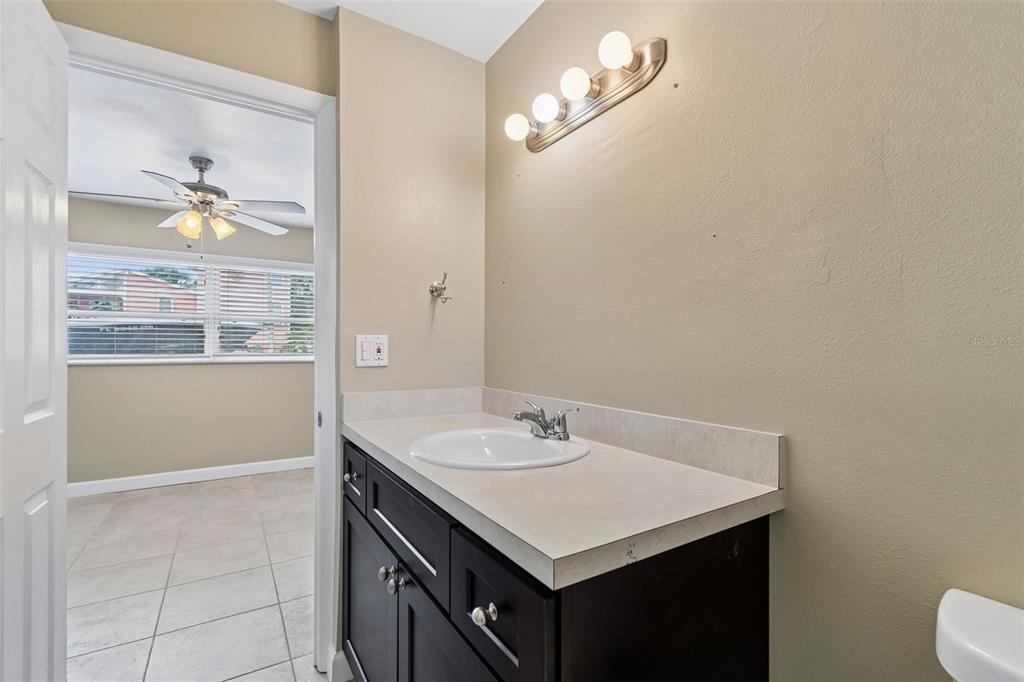2307 Bay Boulevard Indian Rocks Beach, FL 33785 - Photo 73 of 85 a bathroom with a sink a toilet and a mirror