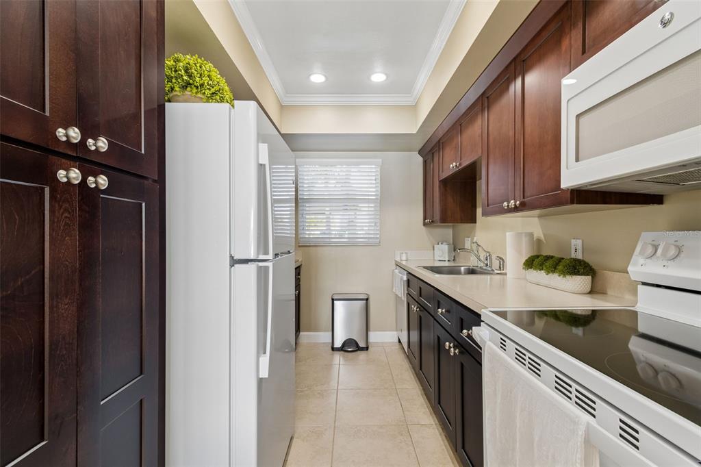 2307 Bay Boulevard Indian Rocks Beach, FL 33785 - Photo 8 of 85 a kitchen with a sink stove and cabinets