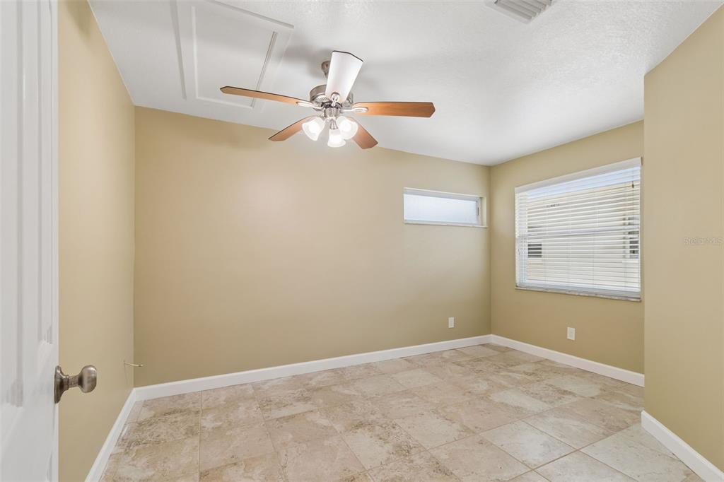 2307 Bay Boulevard Indian Rocks Beach, FL 33785 - Photo 81 of 85 an empty room with a window and a fan