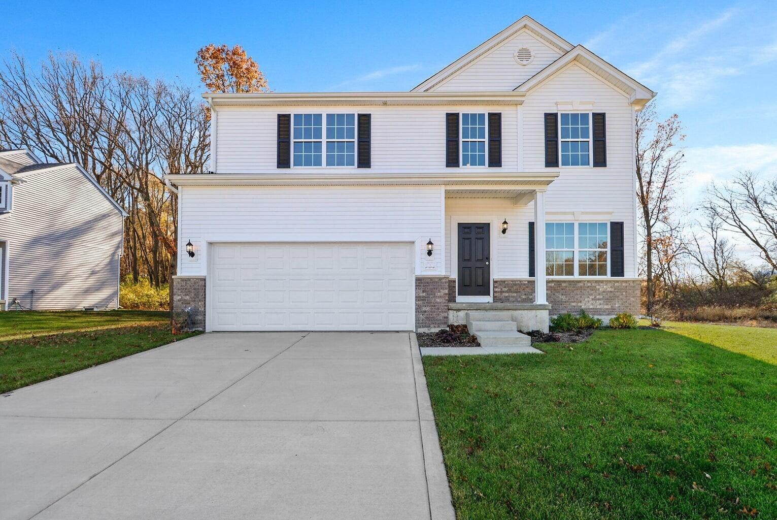 3111 Buck Lane Portage, IN 46368 - Photo 1 of 24 a front view of a house with a yard and garage