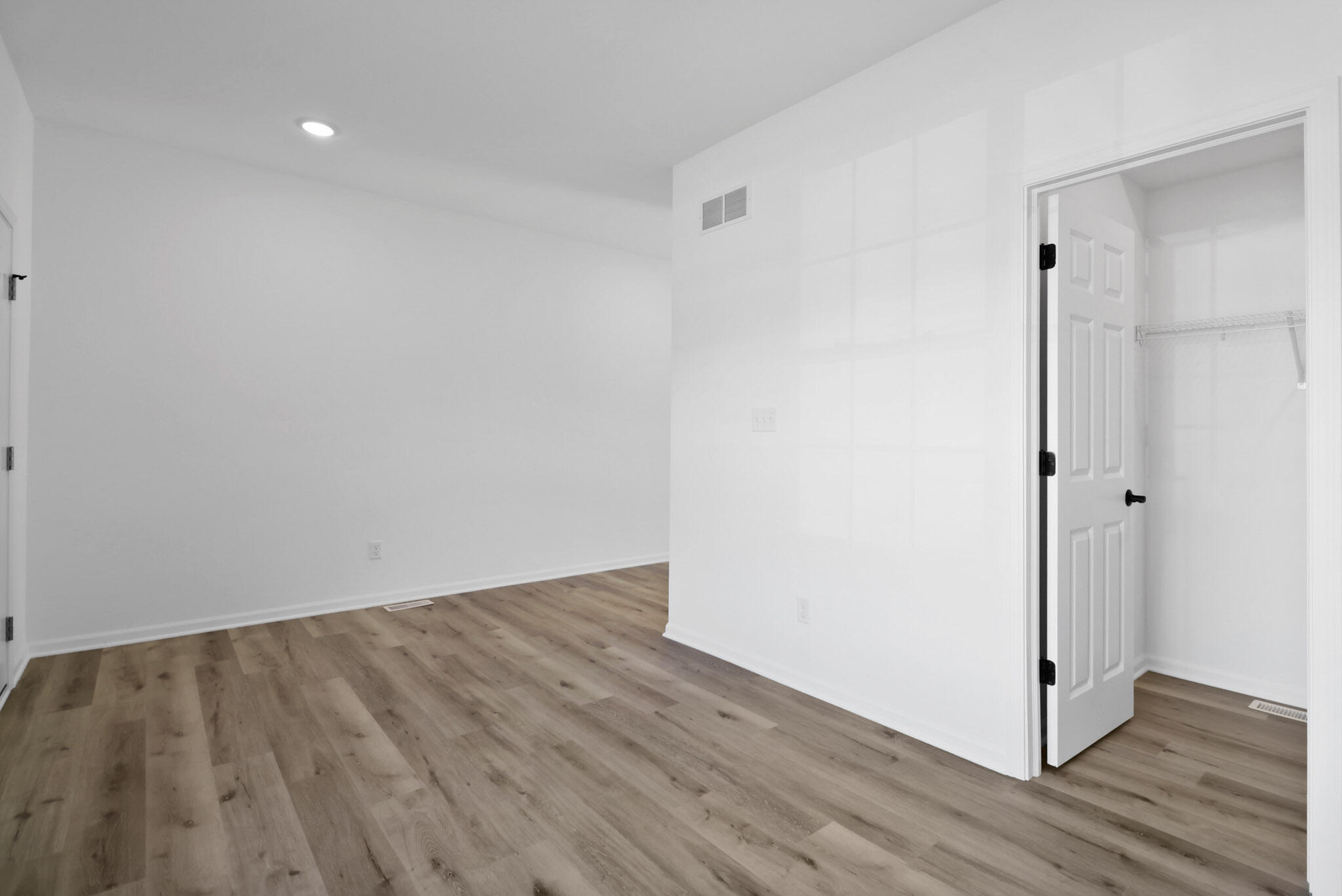 3111 Buck Lane Portage, IN 46368 - Photo 18 of 24 a view of an empty room with wooden floor and a bathroom