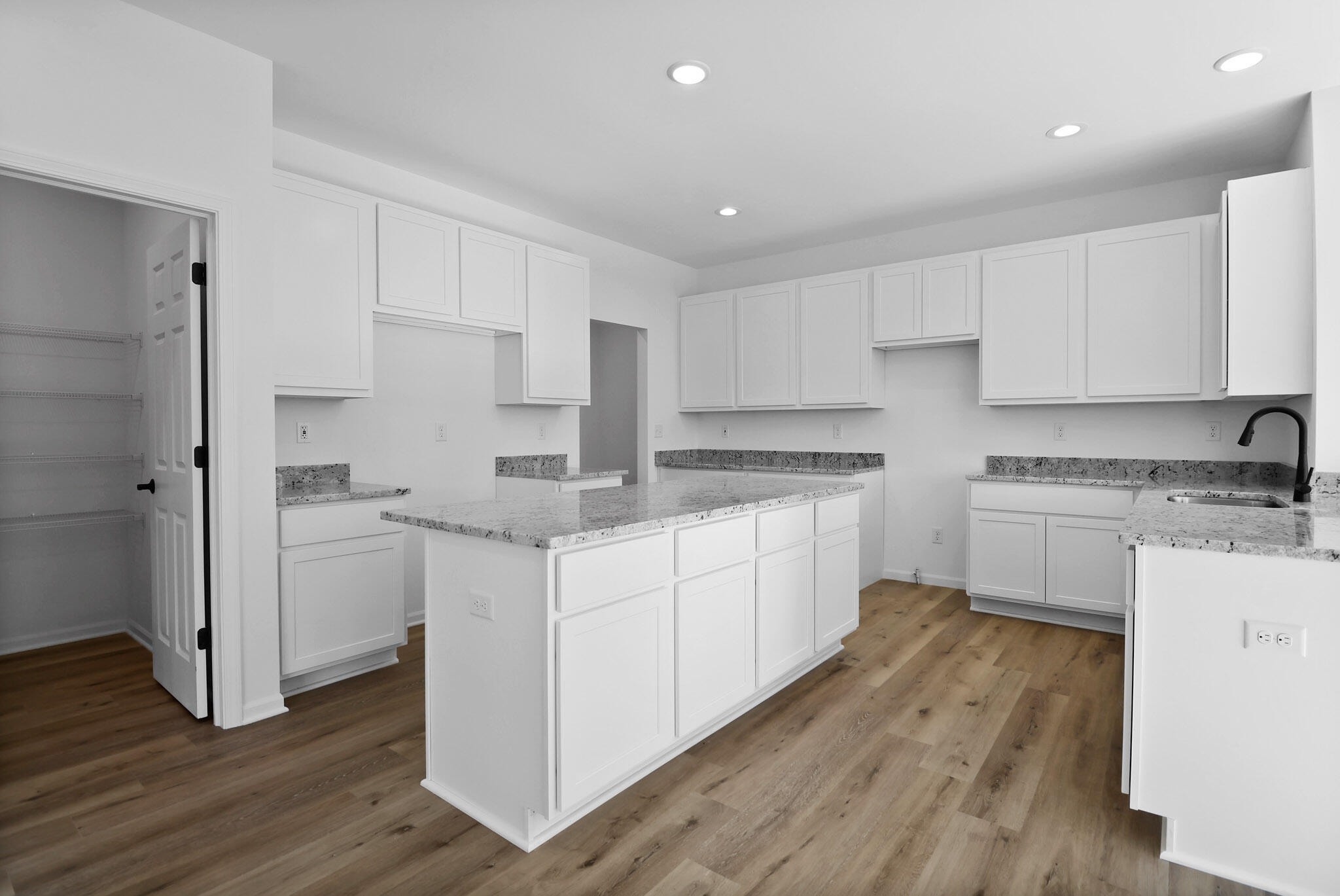 3111 Buck Lane Portage, IN 46368 - Photo 6 of 24 a kitchen with white cabinets stainless steel appliances and wooden floor
