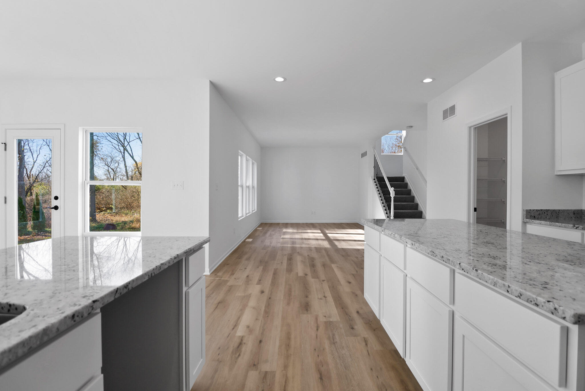 3111 Buck Lane Portage, IN 46368 - Photo 9 of 24 a view of a kitchen with kitchen island a counter top space a sink and wooden floor