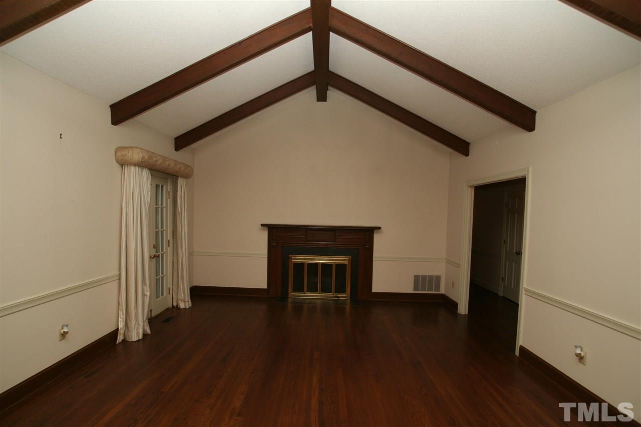 1304 Marlowe Road Raleigh, NC 27609 - Photo 2 of 21 a view of empty room with wooden floor and fireplace