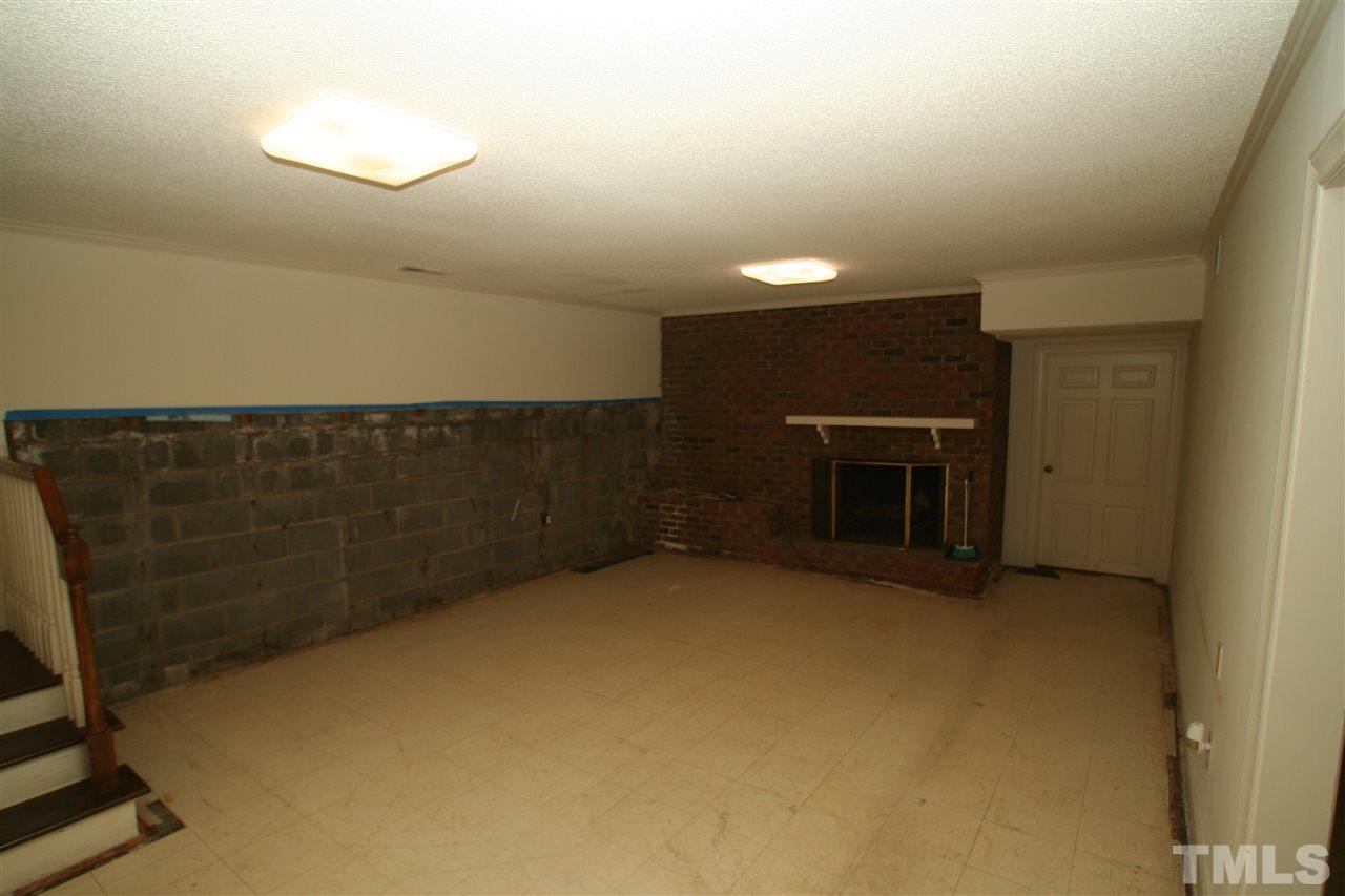 1304 Marlowe Road Raleigh, NC 27609 - Photo 13 of 21 a view of an empty room with a fireplace