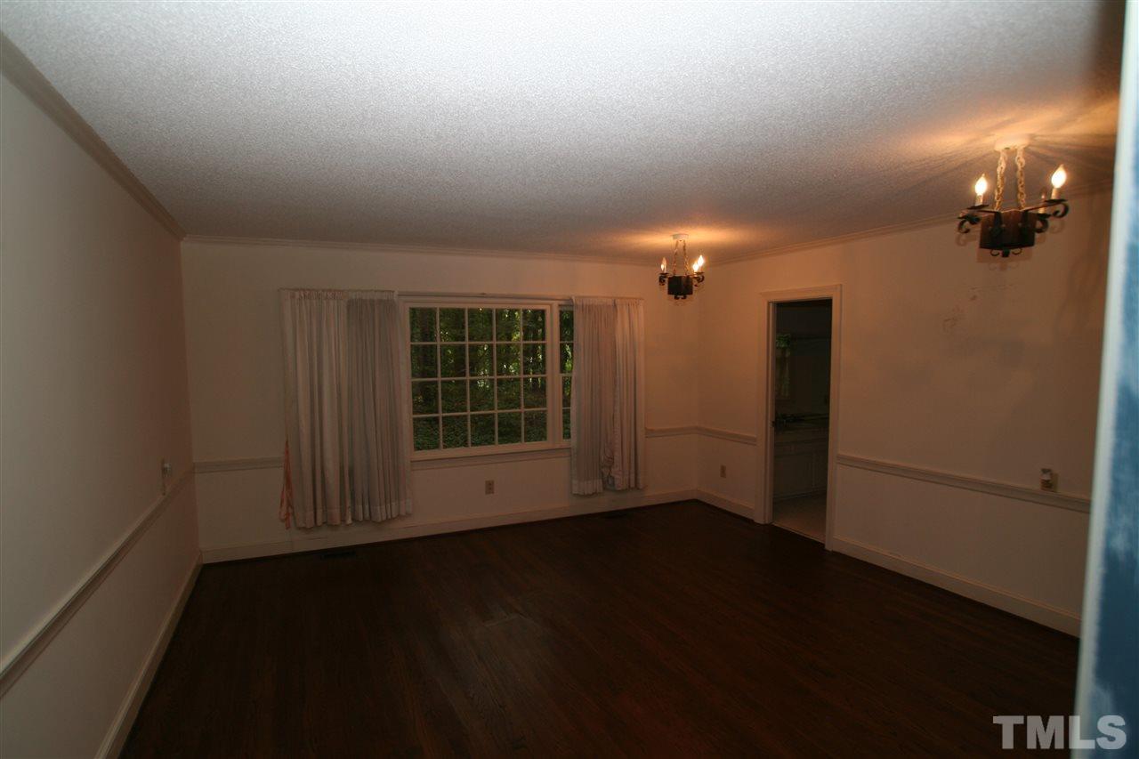 1304 Marlowe Road Raleigh, NC 27609 - Photo 8 of 21 an empty room with wooden floor and windows