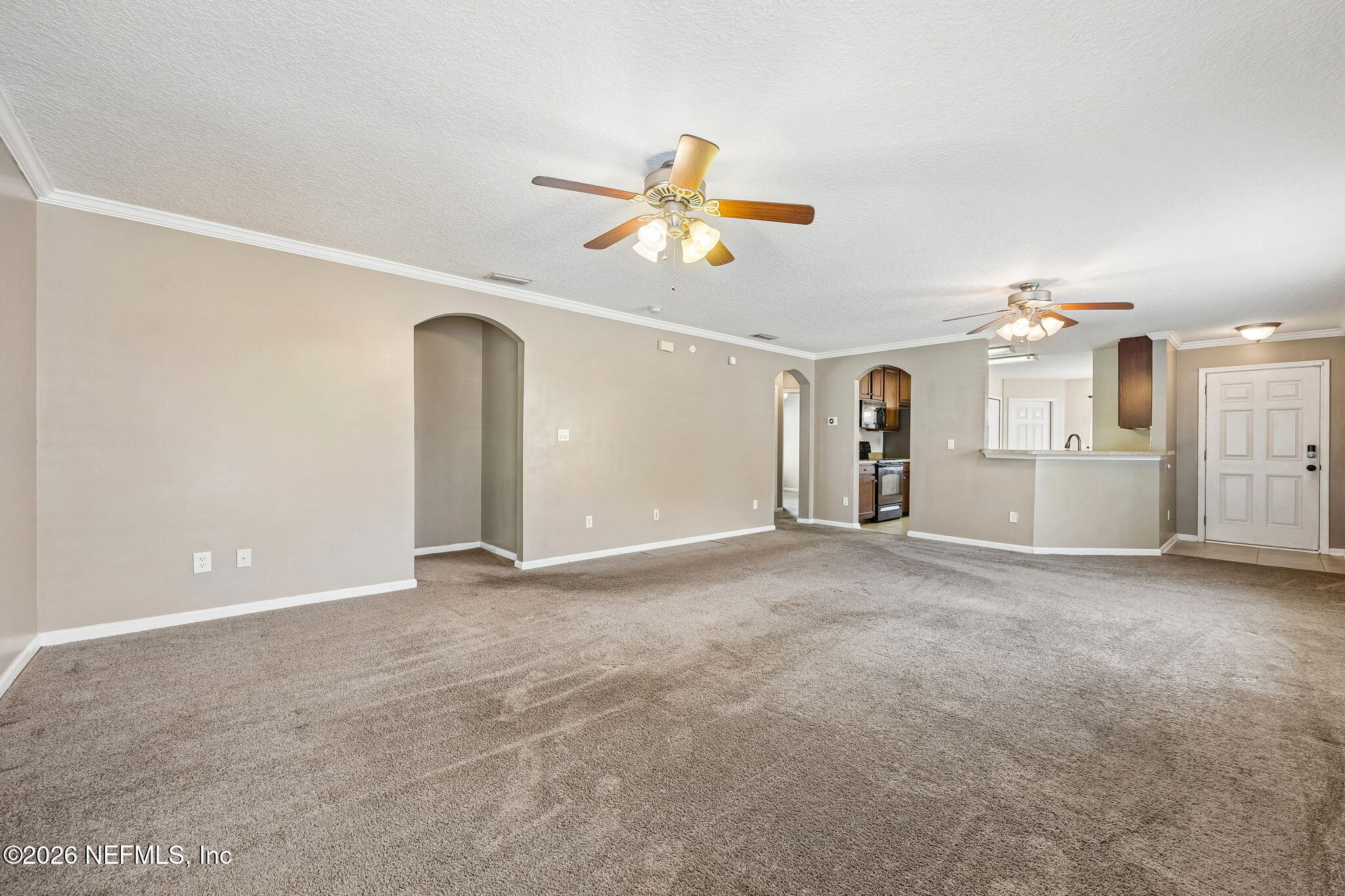 96712 Commodore Point Drive Yulee, FL 32097 - Photo 6 of 24 a view of a kitchen with a sink and a refrigerator