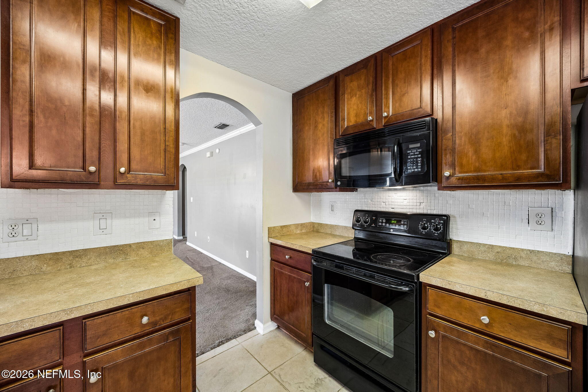 96712 Commodore Point Drive Yulee, FL 32097 - Photo 9 of 24 a kitchen with granite countertop stainless steel appliances and cabinets