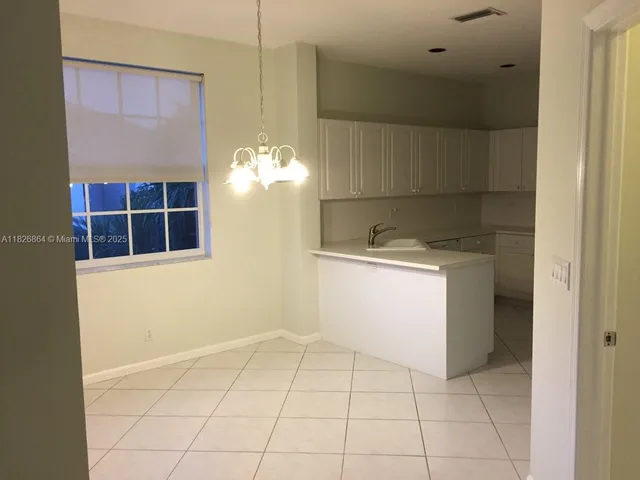 a view of kitchen with cabinets