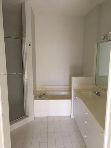 a bathroom with a bathtub and a sink