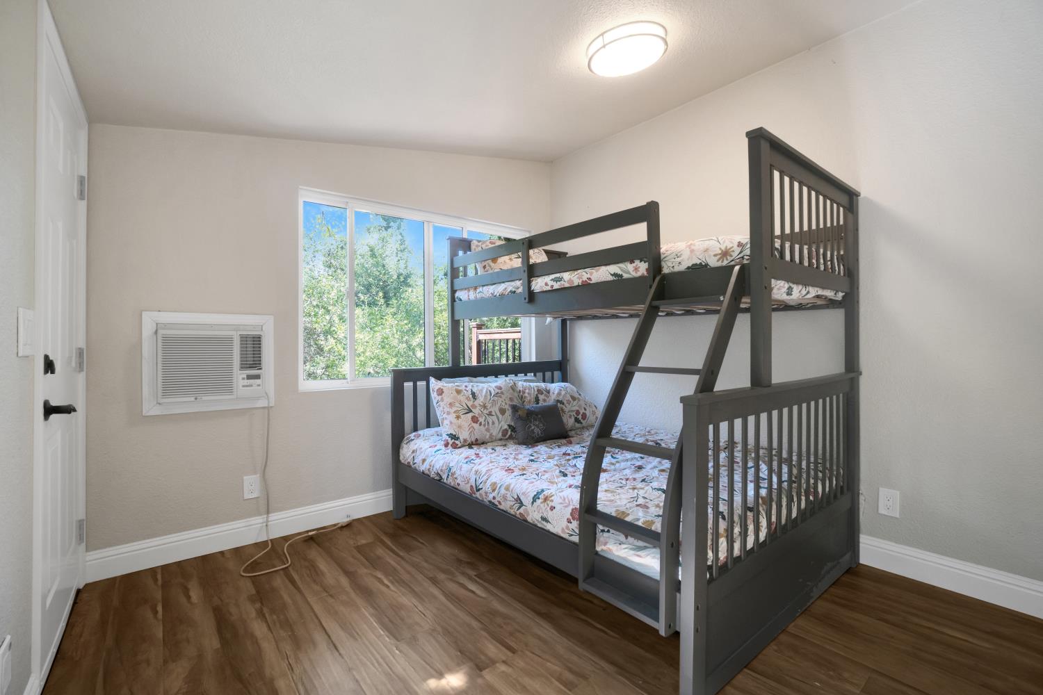6299 Horseshoe Bar Road Loomis, CA 95650 - Photo 21 of 43 a bedroom with a bed and wooden floor