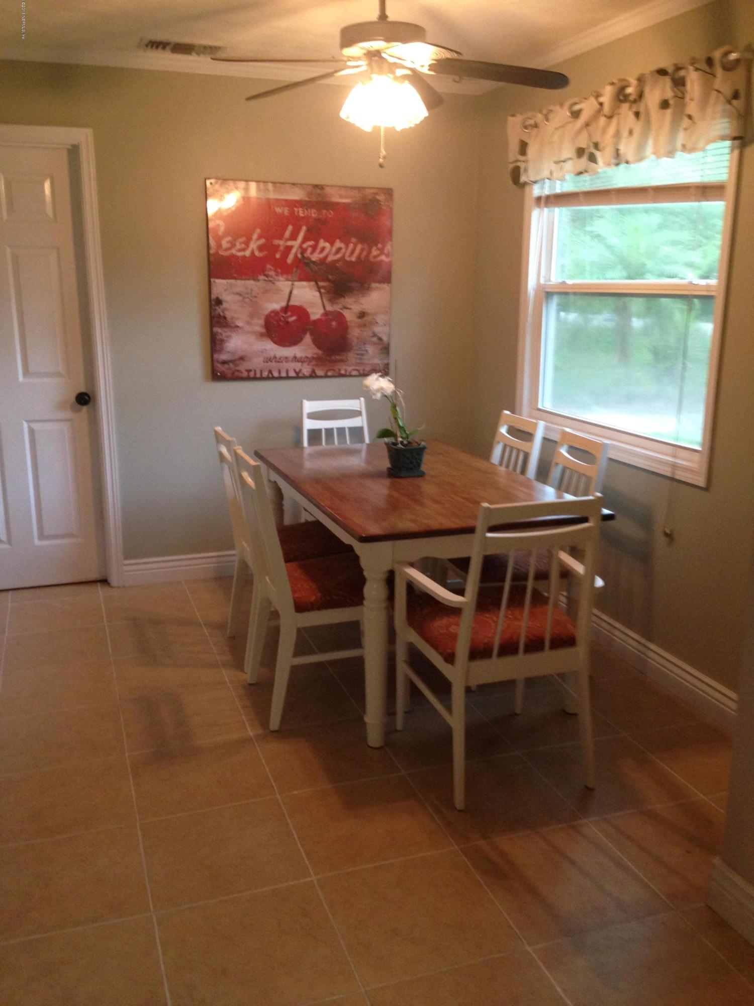 1441 Satsuma Road St. Johns, FL 32259 - Photo 15 of 45 a dining room with furniture a window and a chandelier