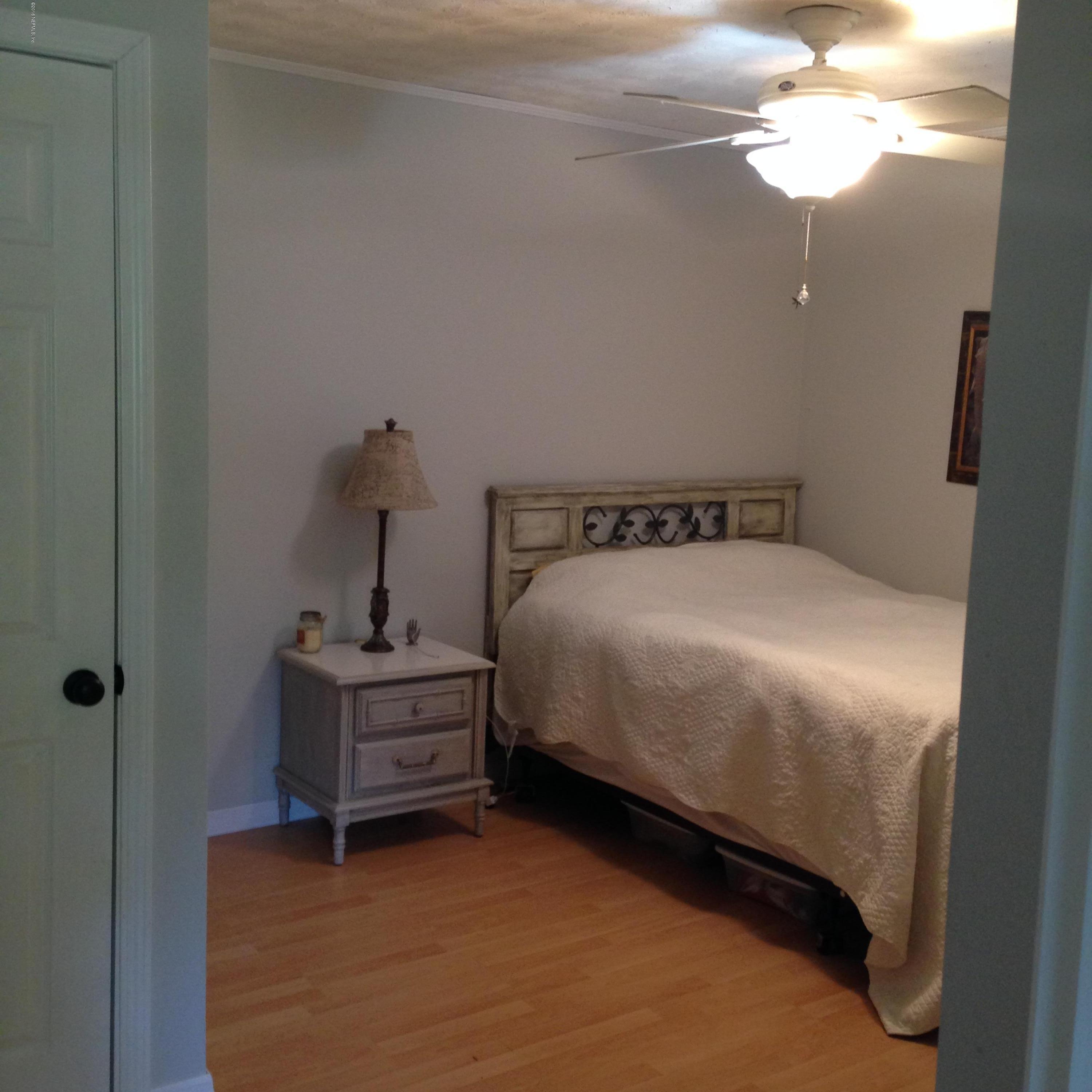 1441 Satsuma Road St. Johns, FL 32259 - Photo 16 of 45 a bed sitting in a bedroom next to a window