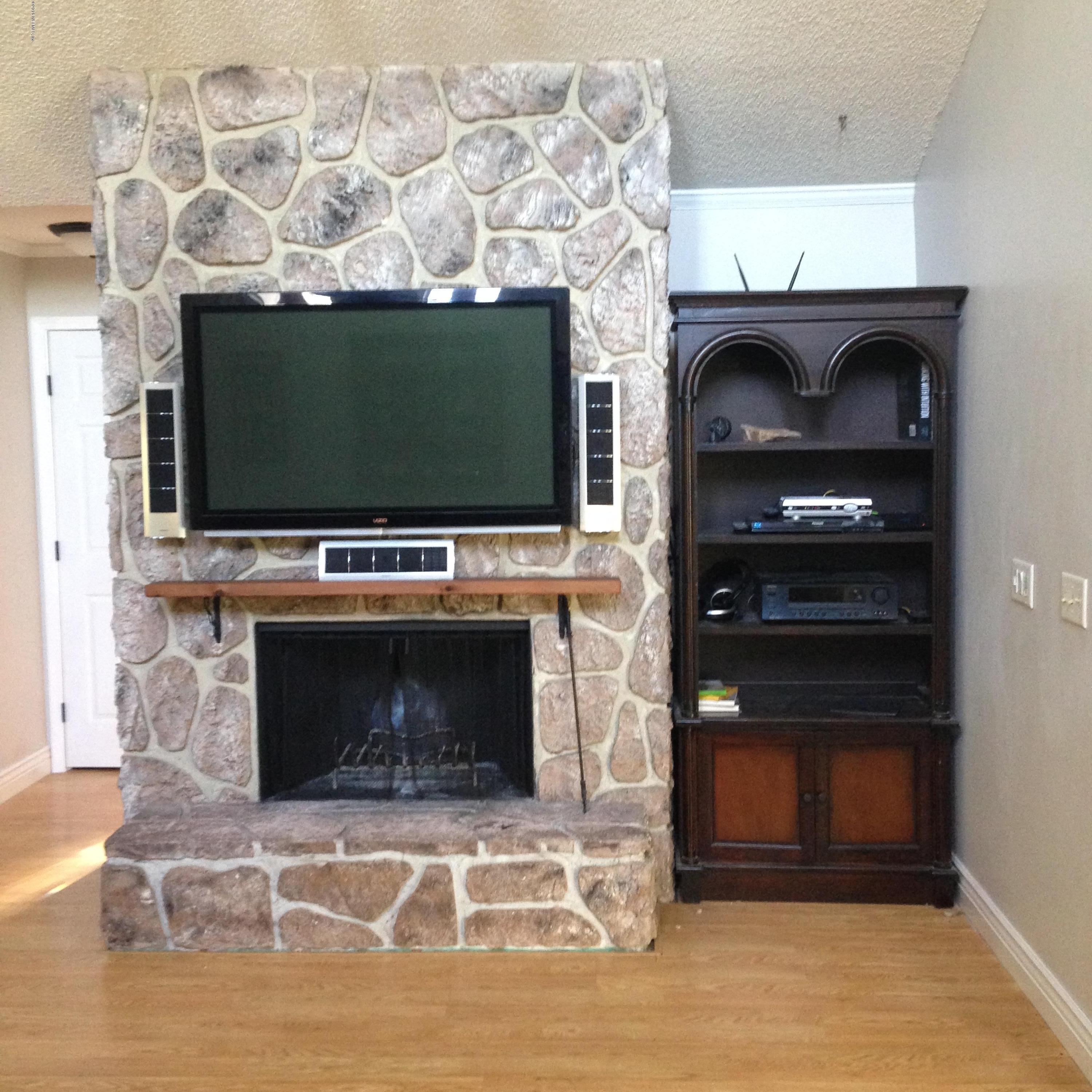 1441 Satsuma Road St. Johns, FL 32259 - Photo 18 of 45 a living room with a fireplace and a flat screen tv