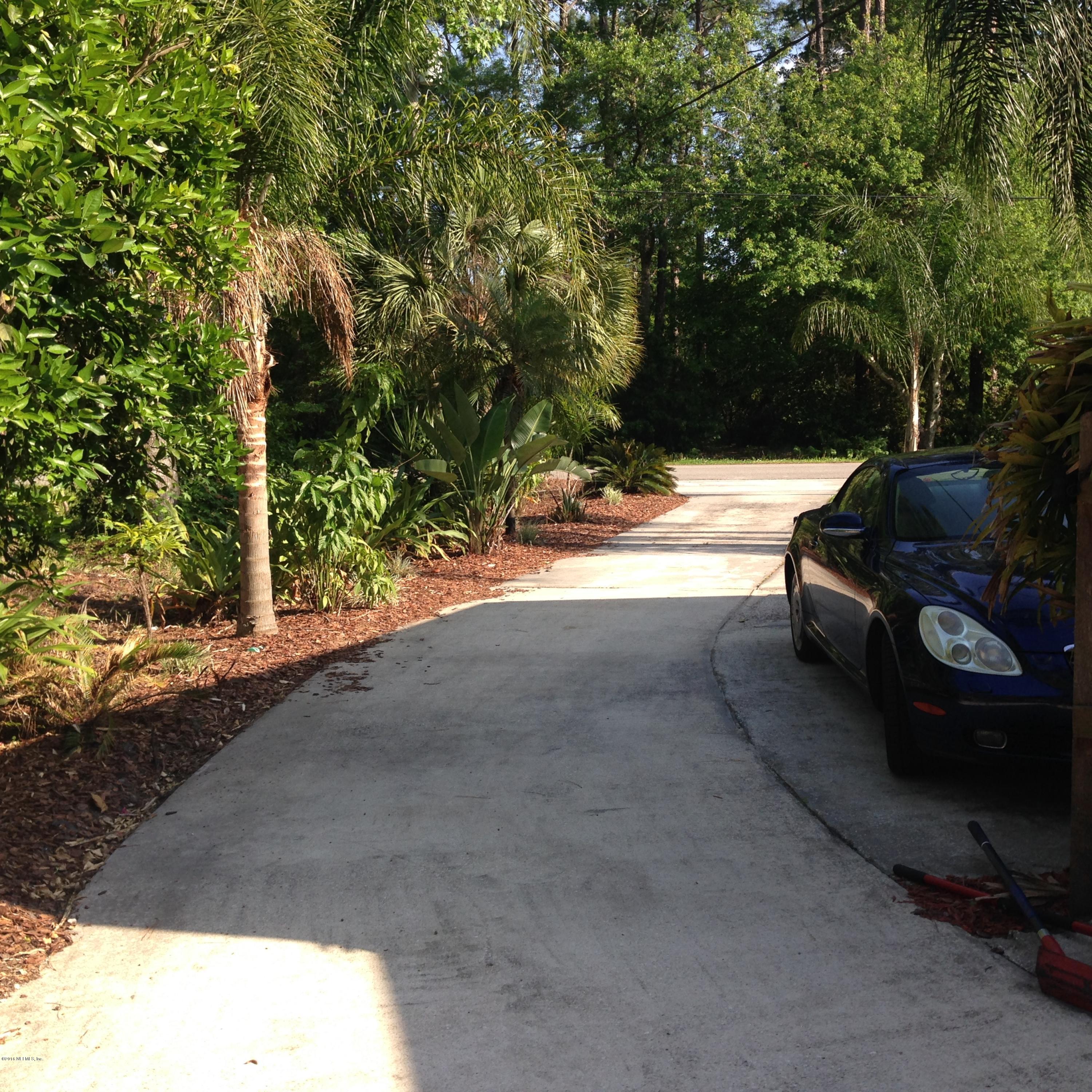 1441 Satsuma Road St. Johns, FL 32259 - Photo 24 of 45 a view of backyard with large tree and wooden fence
