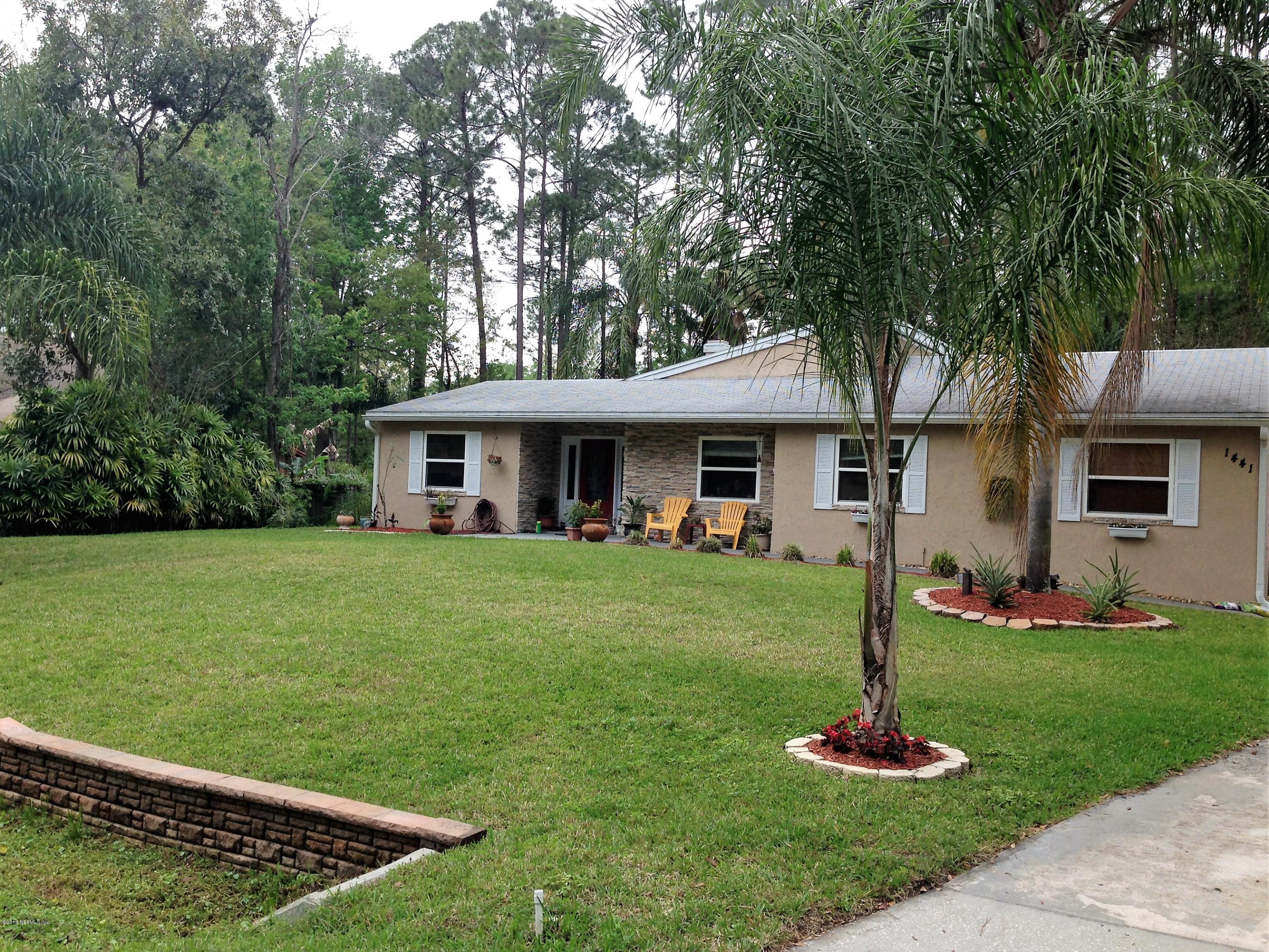 1441 Satsuma Road St. Johns, FL 32259 - Photo 3 of 45 a front view of a house with a yard fire pit and trees