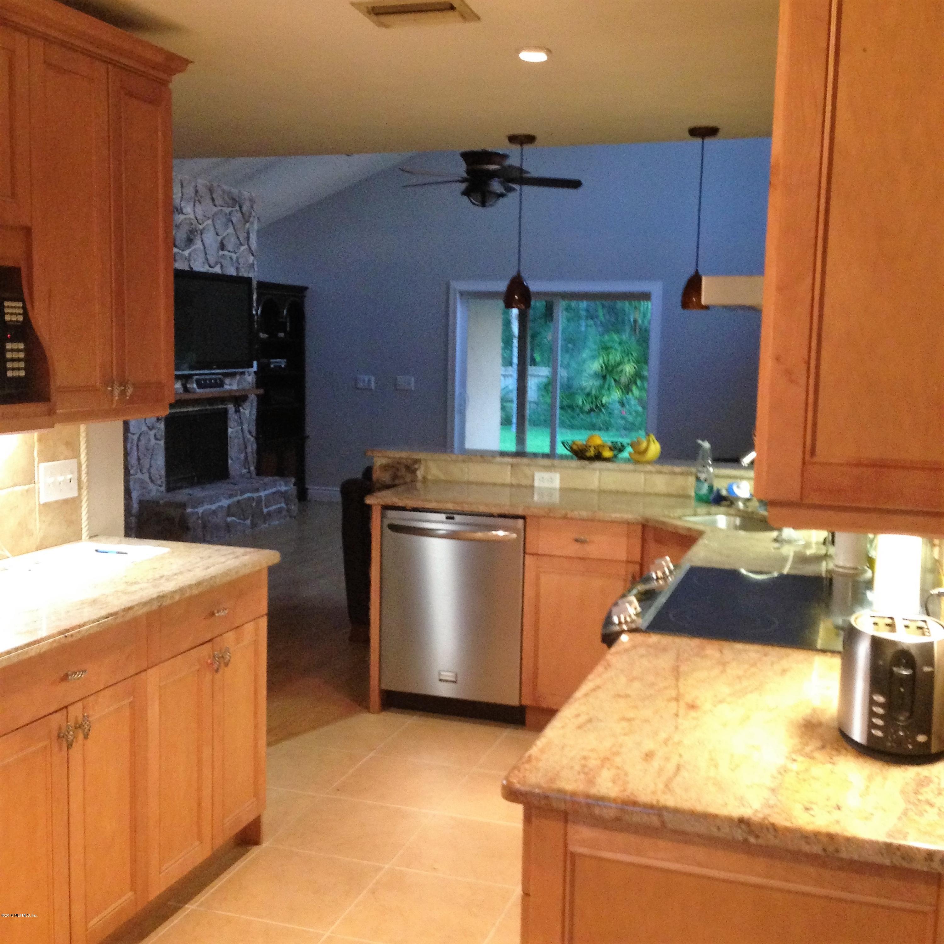 1441 Satsuma Road St. Johns, FL 32259 - Photo 37 of 45 a kitchen with a stove and a refrigerator