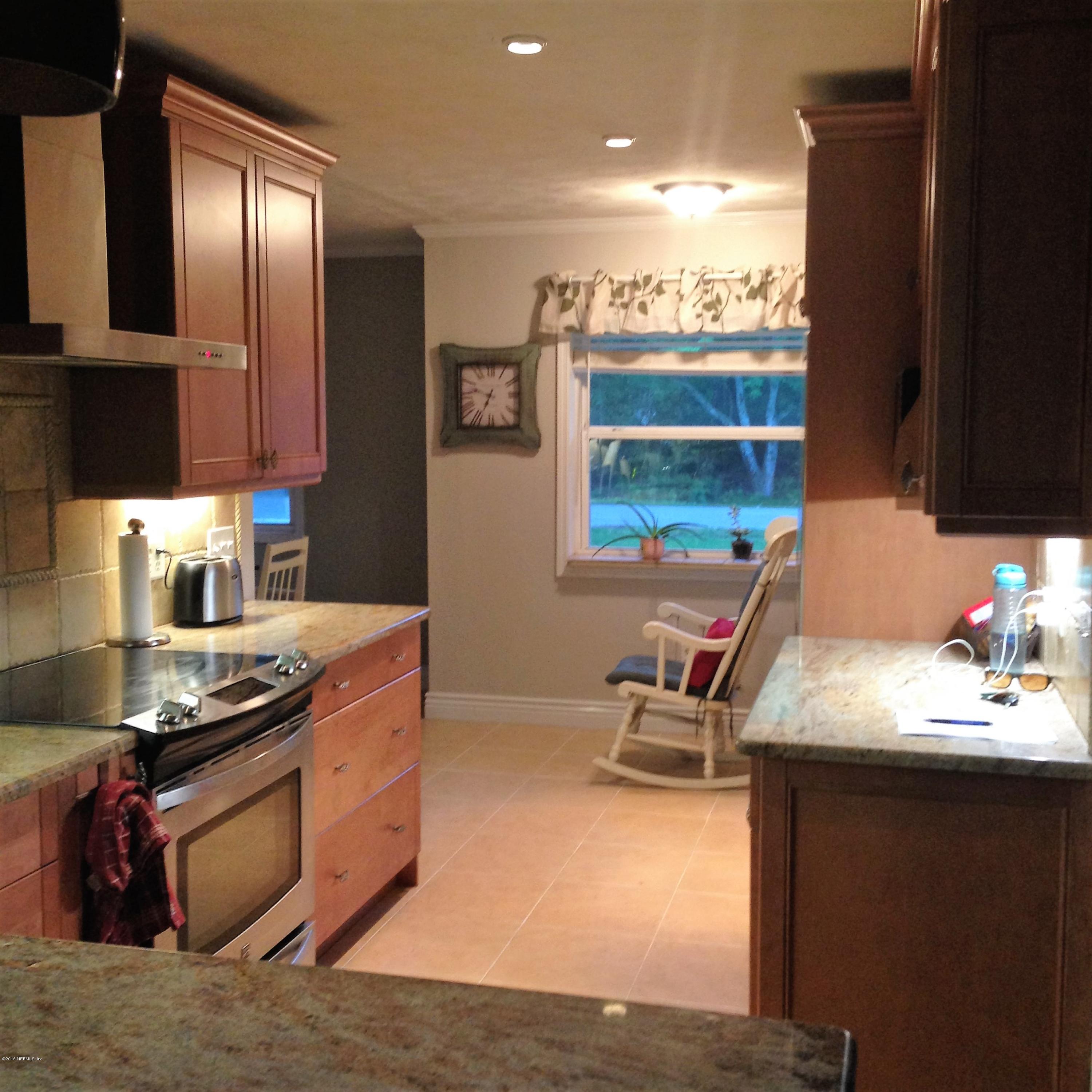 1441 Satsuma Road St. Johns, FL 32259 - Photo 38 of 45 a kitchen with stainless steel appliances granite countertop a stove and a sink