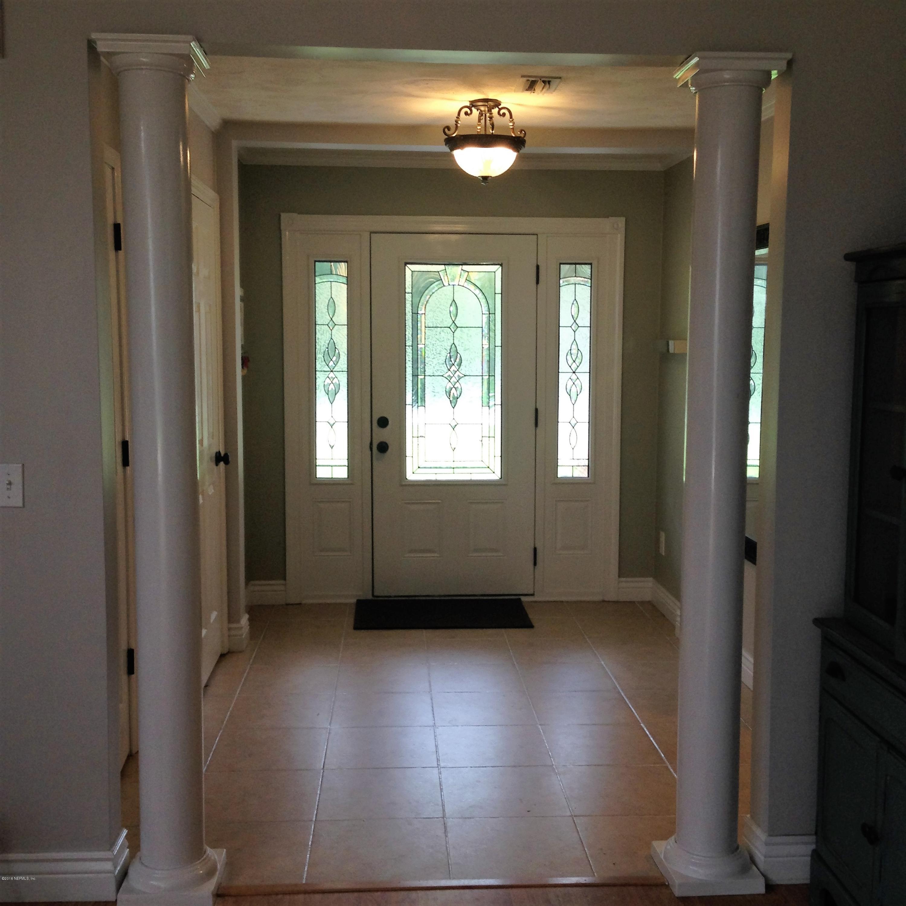 1441 Satsuma Road St. Johns, FL 32259 - Photo 43 of 45 an empty room with windows chandelier and front door