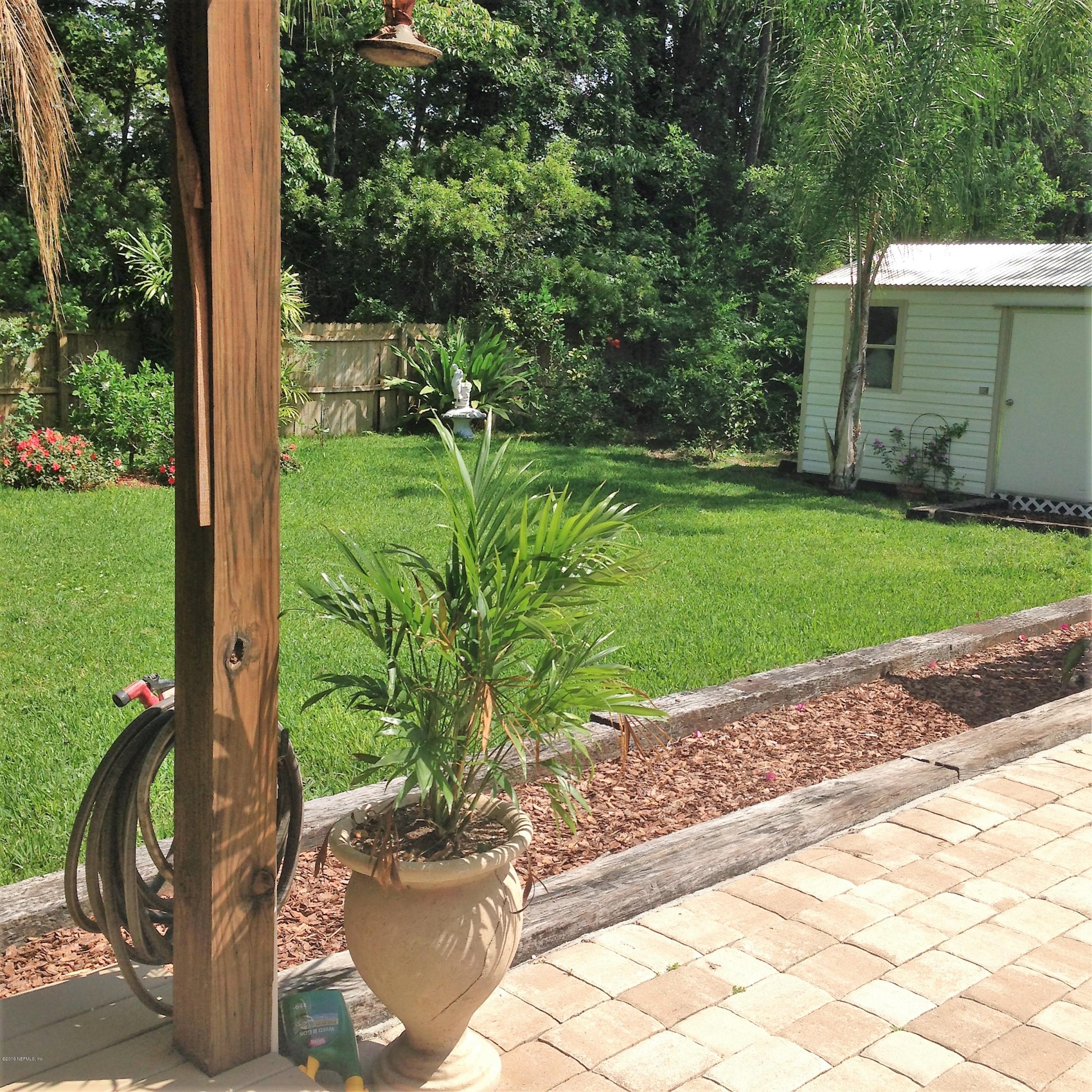 1441 Satsuma Road St. Johns, FL 32259 - Photo 44 of 45 a backyard with potted plants and a bench