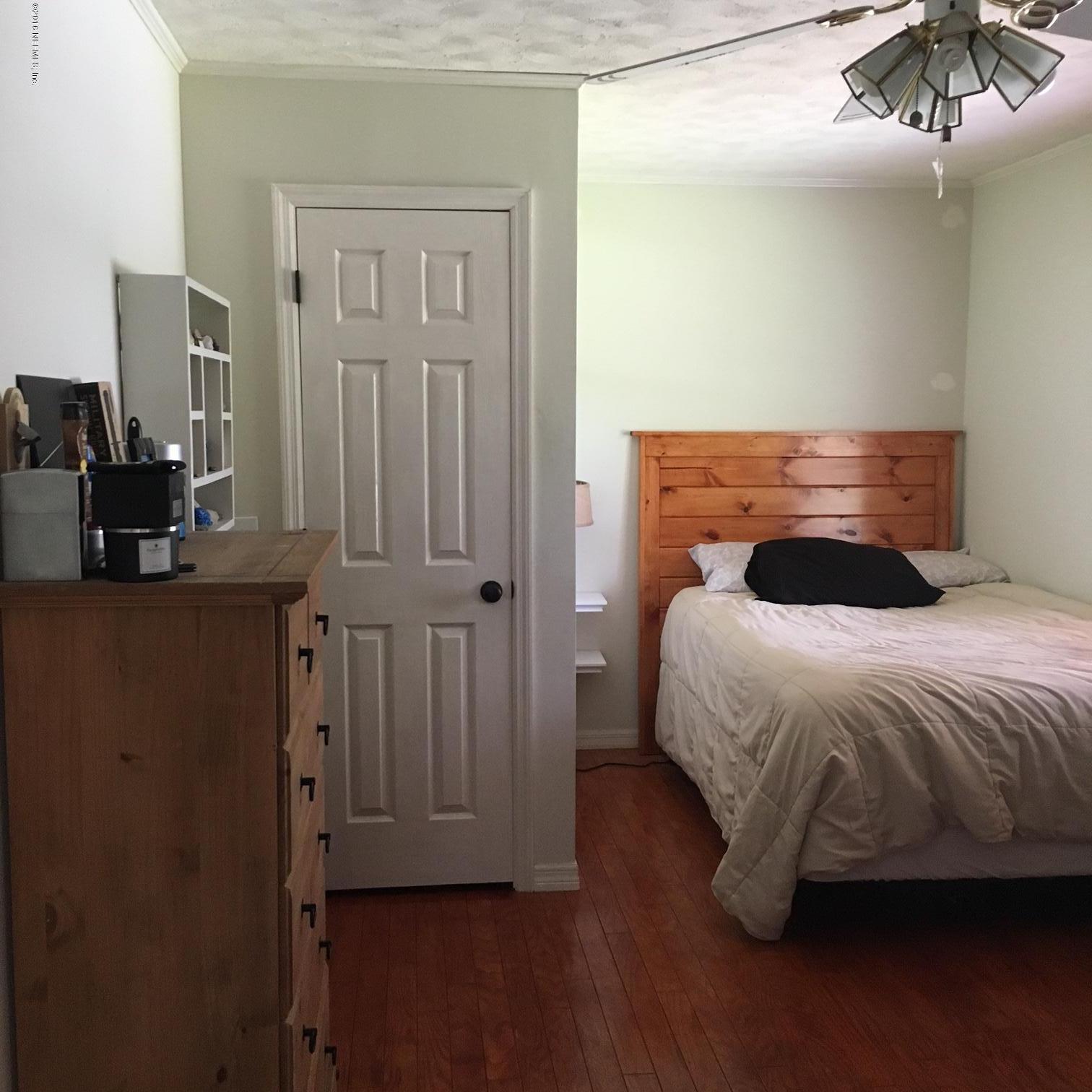 1441 Satsuma Road St. Johns, FL 32259 - Photo 9 of 45 a bedroom with a bed and a chandelier