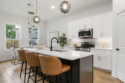 a kitchen with appliances a sink and cabinets