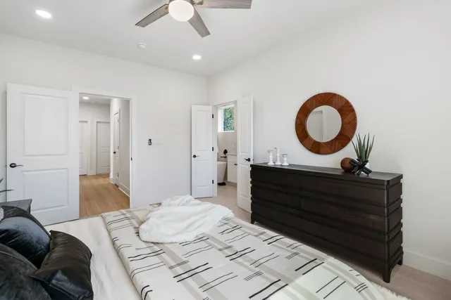 a living room with a bed furniture and a dresser