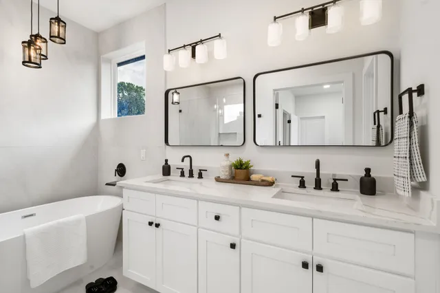 a bathroom with a double vanity sink and a mirror