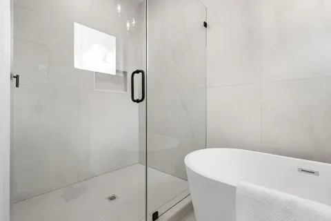 a bathroom with a shower and a shower