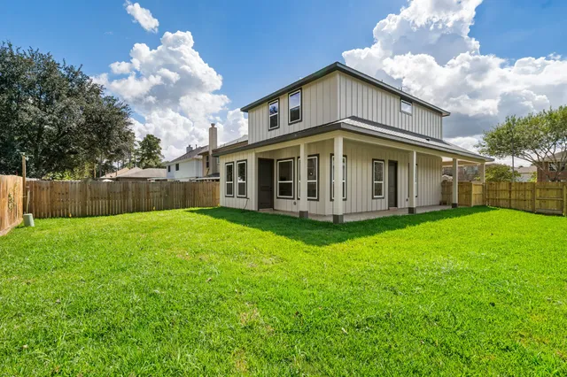a view of a house with yard and sitting area