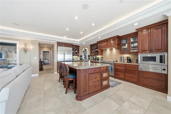a kitchen with lots of wooden cabinets appliances and furniture