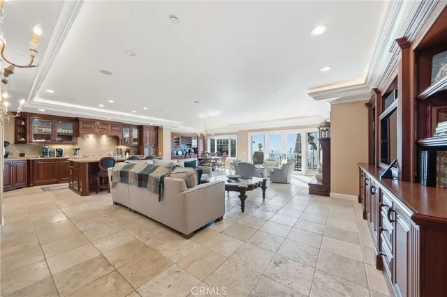 a living room with furniture fireplace and a large window
