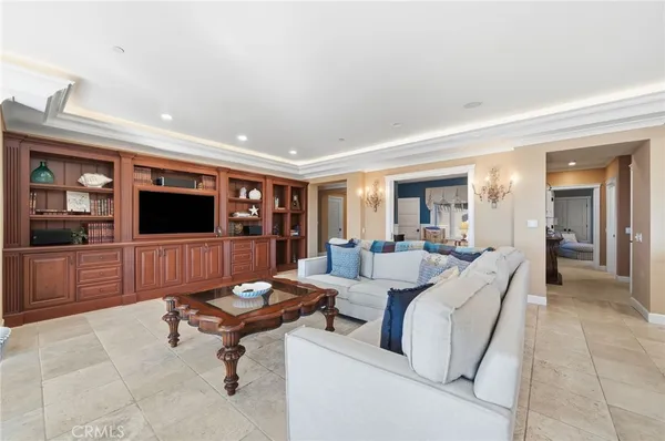 a living room with furniture fireplace and a large window