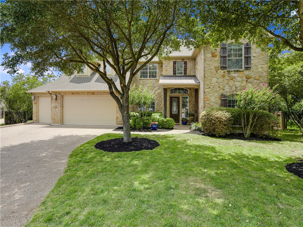7929 Crandall Road Austin, TX 78739 - Photo 1 of 1 a front view of a house with a garden and plants