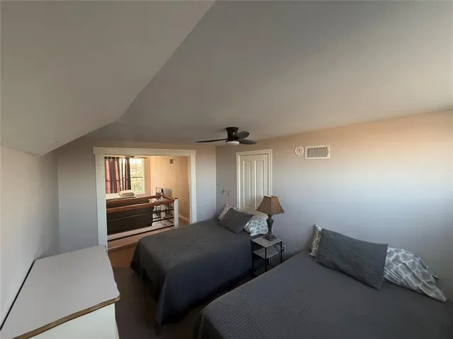 a bedroom with two beds and a couch