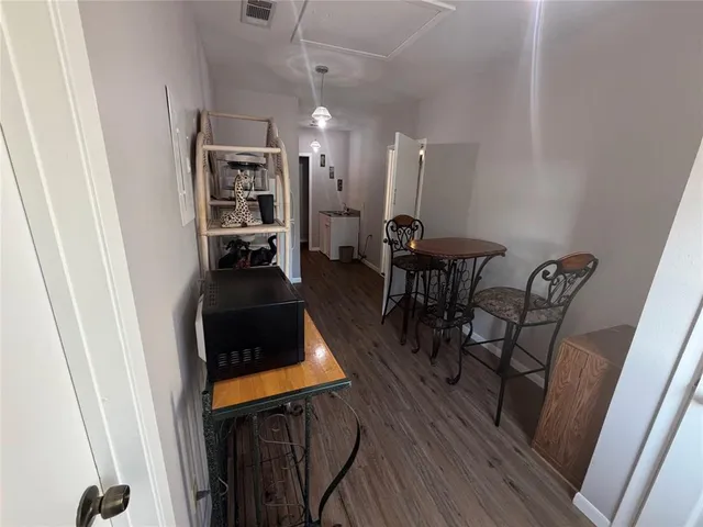 a view of a workspace with furniture and wooden floor