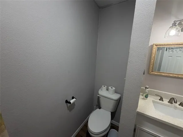a white toilet sitting next to a bathroom sink