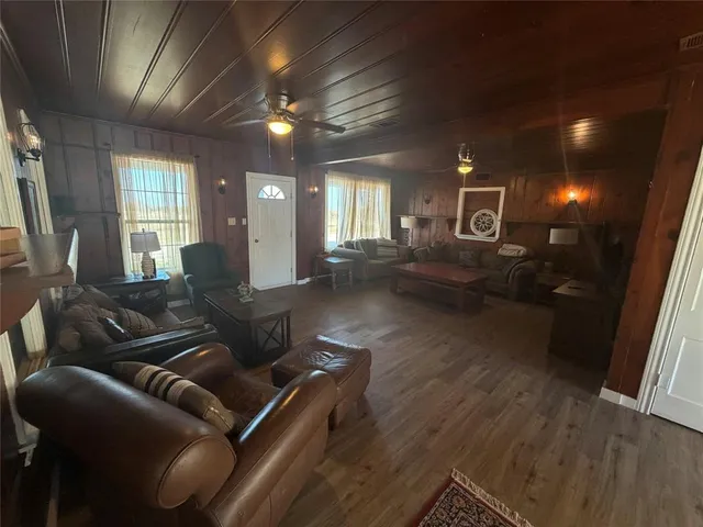 a living room with furniture and a wooden floor