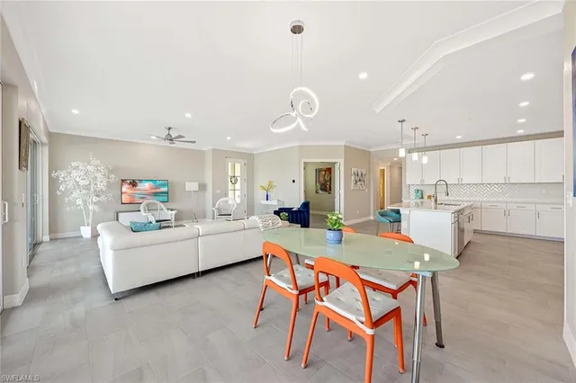 a living room with furniture and a kitchen view
