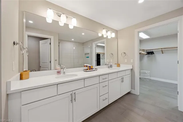 a bathroom with a double vanity sink mirror and