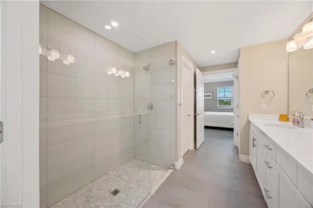 a bathroom with a double vanity sink a toilet and shower