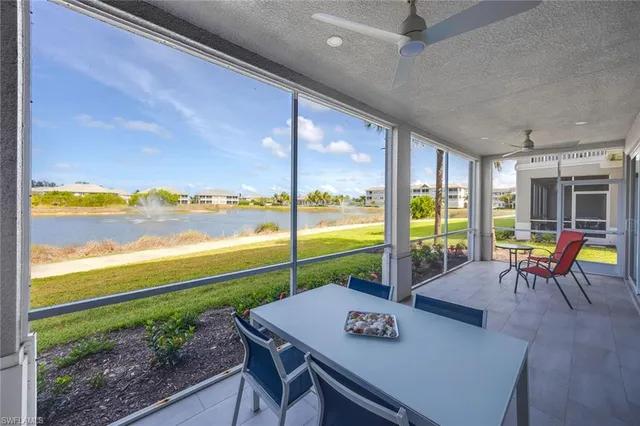 a living room with furniture and floor to ceiling windows