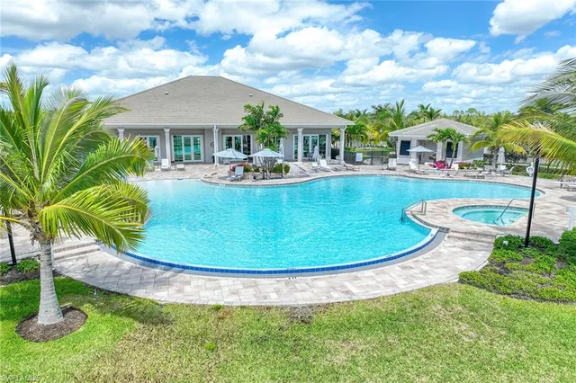 a view of a swimming pool with outdoor seating and lake