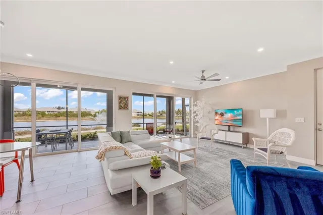 a living room with furniture and a floor to ceiling window