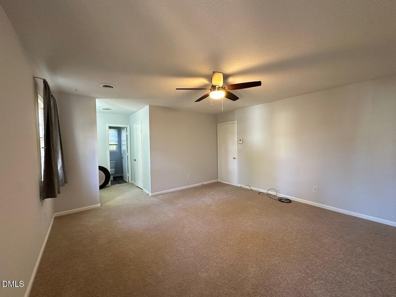 3717 Sue Ellen Drive Raleigh, NC 27604 - Photo 13 of 20 an empty room with fan and entrance