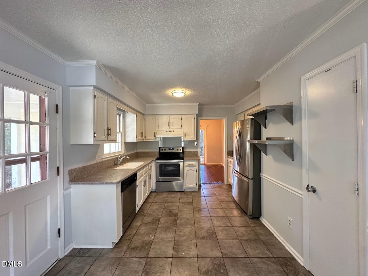 3717 Sue Ellen Drive Raleigh, NC 27604 - Photo 4 of 20 a kitchen with stainless steel appliances granite countertop a refrigerator and a sink
